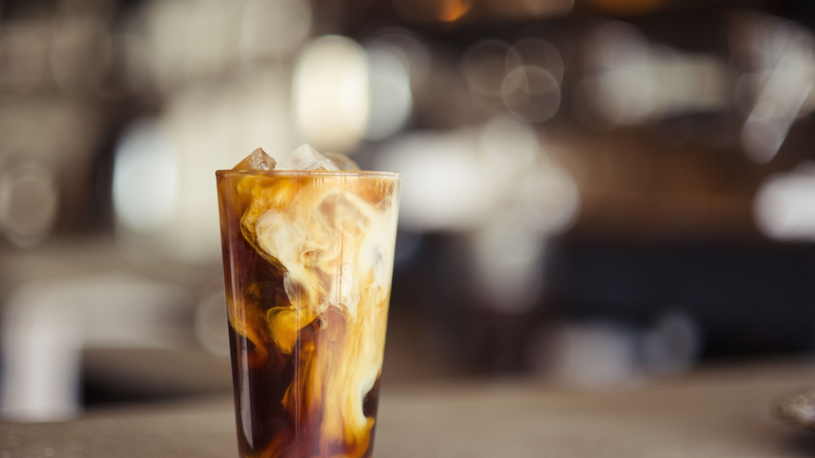 A tall glass of iced cold brew coffee with ice cubes