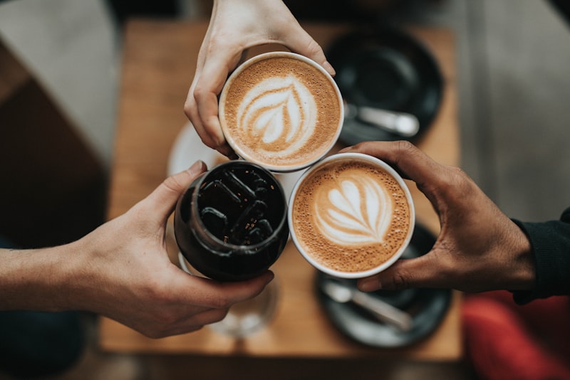 A mug of coffee beside a window in soft morning light