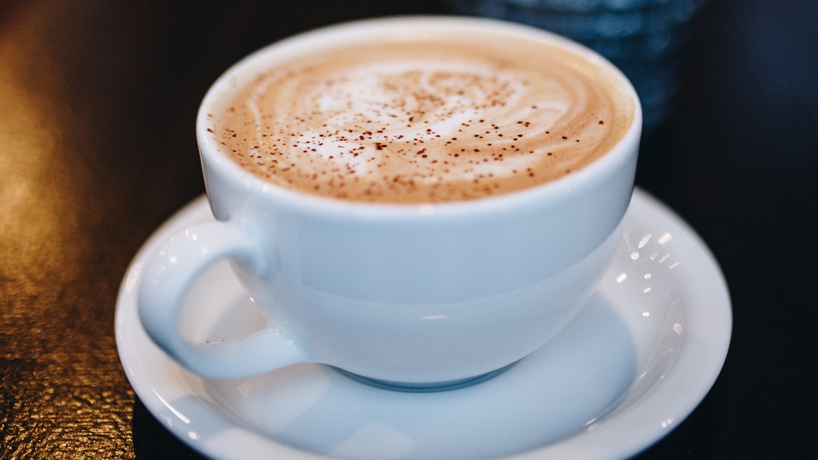 A glass French press filled with dark brewed coffee on a counter