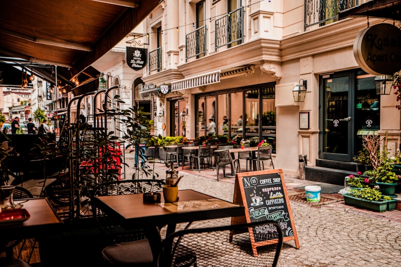 People talking and working at tables in a cozy neighborhood cafe